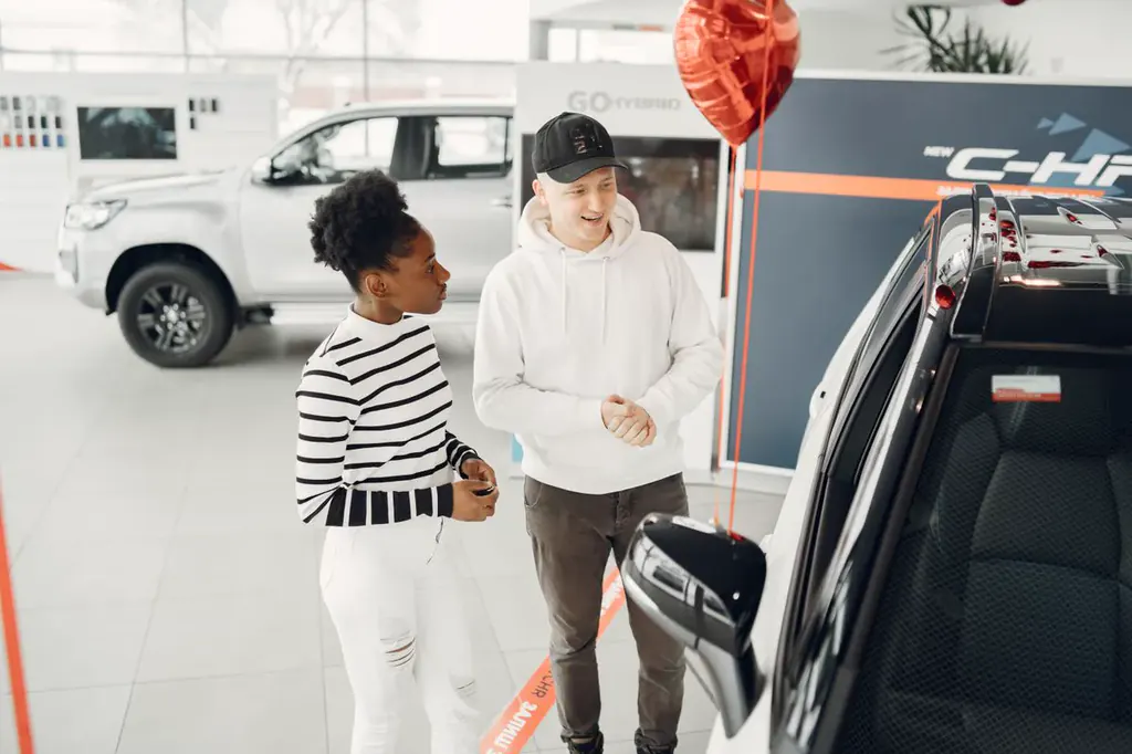 A couple exploring vehicles in a showroom